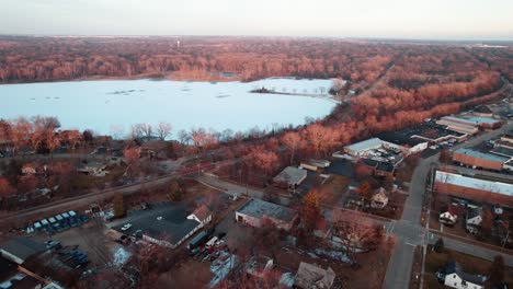 overhead-drone-shot-above-frozen-Minear-Lake-winter-from-Libertyville,-Illinois,-USA-sunset-aerial-4k