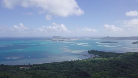 Weite-Landschaftsaussicht-Auf-Eest-Honolulu-Oahu-Hawaii-Und-Das-Klare-Blaue-Pazifikwasser-Und-Die-Insel-Im-Hintergrund-Mit-Weißen-Flauschigen-Wolken,-Luftwagen