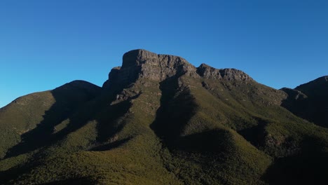 Aerial-orbit-of-towering-rocky-mountain-in-Australian-outback