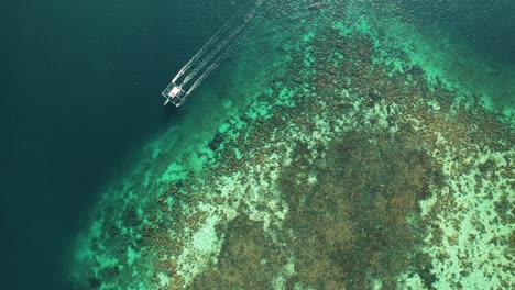 4k-Aerial-View-of-Catamaran-Sailing-by-Reef-in-Coron,-Palawan-Philippines