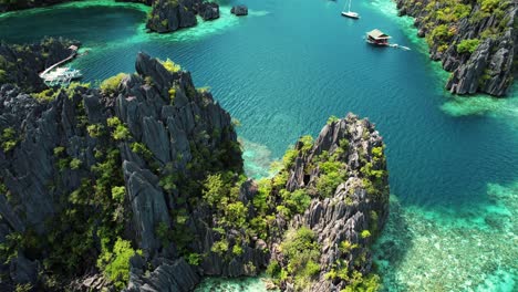4k-Drone-Circles-Karst-Cliffs-at-Twin-Lagoon,-Coron,-Palawan-Philippines