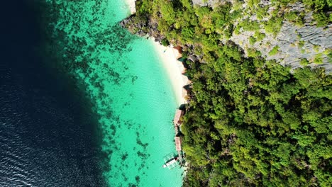4k-Drone-Descending-to-Girl-Floating-In-Turquoise-Water,-Palawan-Philippines