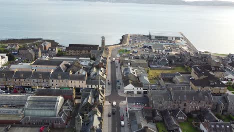 Flight-over-a-street-with-any-cars-driving-on-it-in-the-village-of-Helensburgh-with-sea-views