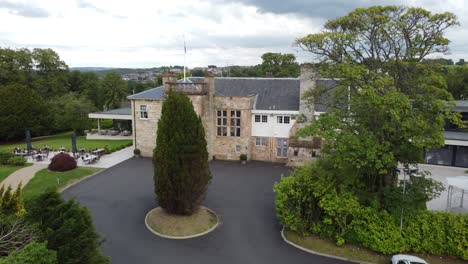 Ascending-Aerial-video-over-Dalmeny-Park,-a-luxurious-Scottish-country-mansion-hotel-