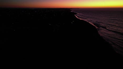Stunning-aerial-view-of-golden-sunset-beyond-peninsula-in-Western-Australia