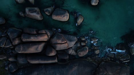 Top-down-aerial-view-of-giant-elephant-rocks-in-the-ocean