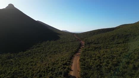 Aerial-shot-of-empty-dirt-road-cutting-through-mountains-in-Australian-outback