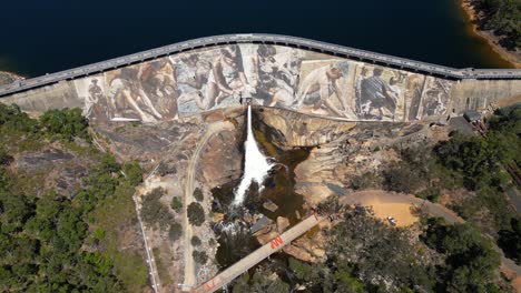 Orbiting-aerial-of-giant-panoramic-mural-painted-on-active-dam-in-Western-Australia