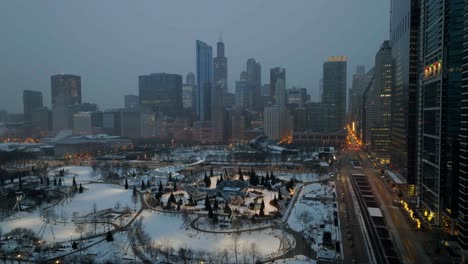 Aerial-view-over-the-Maggie-Daley-Park-Ice-Skating-Ribbon,-foggy,-winter-evening-in-Chicago,-USA