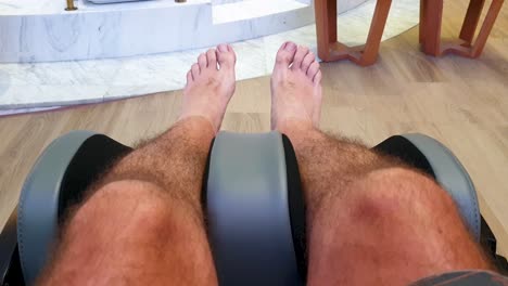 First-person-view-of-automatic-massage-chair-massaging-persons-legs-and-calf-muscles,-self-care-and-pampering-at-health-and-beauty-spa-salon