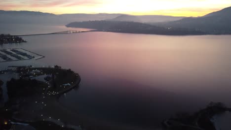 drone-shot-of-kelowna-city-and-buildings-on-Okanogan-lake-with-sunset