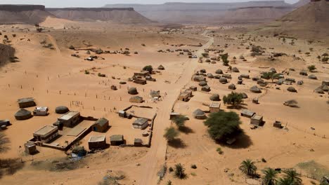 Thatch-Huts-in-Terjit-Oasis-Village-in-Mauritania,-Africa---Aerial-Drone