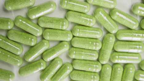 Close-up-and-top-shot-of-green-marijuana-capsule-or-pill