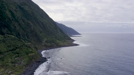 Drone-view-of-island-coastal,-lush-green-cliffs-landscape,-Fajã-de-Santo-Cristo,-São-Jorge-island,-the-Azores,-Portugal