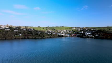 Flying-backwards,-an-aerial-wide-panorama-over-Summercove-village-in-Kinsale,-Co