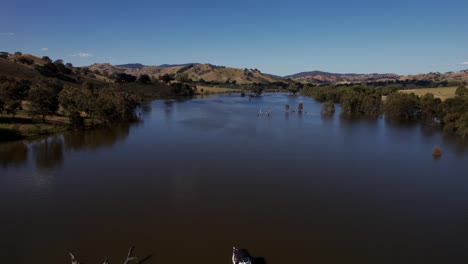 Lake-Eildon-surrounded-by-hills-and-farmland-aerial-nature,-Australia