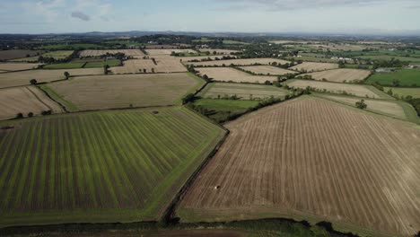 Daytime-drone-flight-over-Irish-fields,-showing-the-landscape