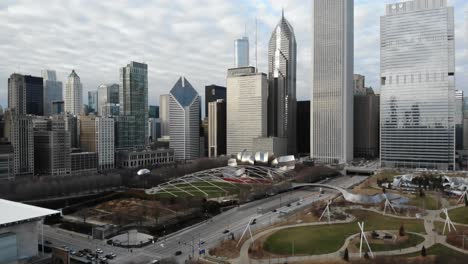 Chicago-USA,-Aerial-View-of-Millennium-Park,-Skyscrapers,-Towers-and-Traffic-on-Cloudy-Autumn-Day