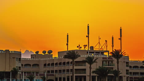 Big-Masts-and-Antenna-on-top-of-a-building-roof-with-sunset-sky-in-tropical-city