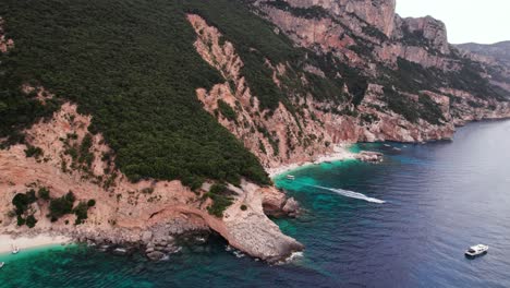 Aerial-crane-shot-of-rocky-coast-in-the-mediterranean-sea,-Sardinia