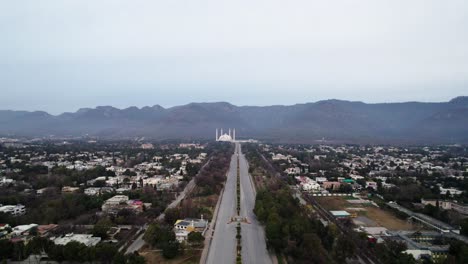 Morning-Aerial-view-of-Faisal-Mosque-from-a-distance-Islamabad-Pakistan-2023,-drone-footage-of-Famous-landmark-of-Islamabad-Pakistan,-video-taken-early-morning