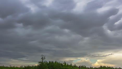 Rain-clouds-flow-above-forestry-area,-fusion-time-lapse