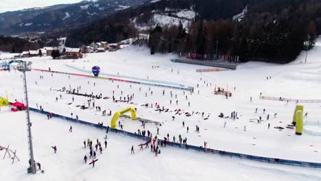 Aerial-reveal-tilt-down-shot-of-cross-country-skiers-in-Val-di-Fiemme-Italy