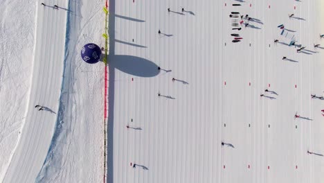 Straight-down-drone-shot-over-skiers-in-Italian-alp-village
