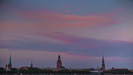Colorful-cloudscape-roll-above-Riga-skyline,-fusion-time-lapse-view