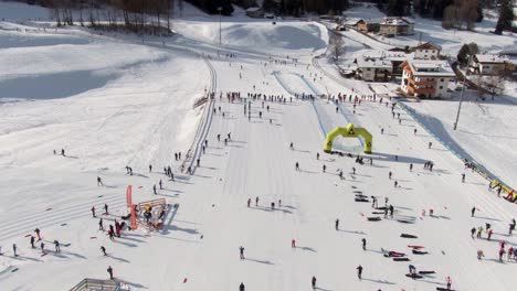 Aerial-bird's-eye-view-over-Trentino-Italy-and-skiers-prior-to-race