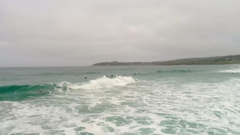 Carmel-By-The-Sea-Beach-Drone-Video-Foggy-Morning-Surfers-on-Waves---Circling-surfers
