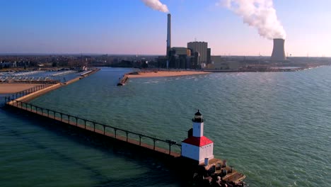 Michigan-City-lighthouse-and-pier-on-lake-with-electrical-substation-and-Washington-Park-beach-in-background,-Indiana