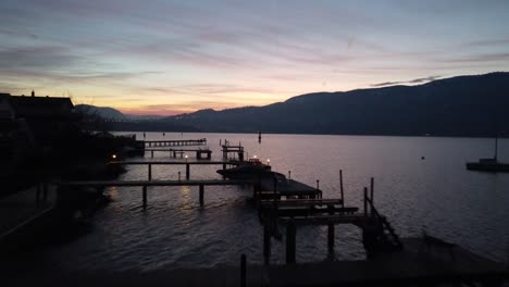 drone-shot-of-kelowna-city-beach-docks-on-Okanogan-lake-with-sunset