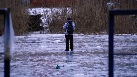 A-fisherman-teases-a-fish-that-is-under-the-ice