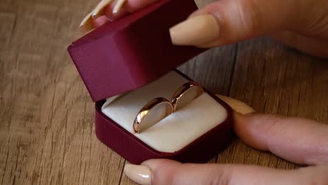 closeup-wedding-rings-on-in-a-box-when-the-woman-closes-the-box