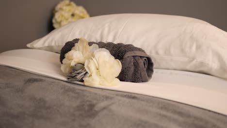Towel-And-Flower-On-A-Cosy-Spa-Bed