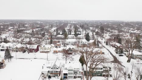 Aerial,-neighborhood-suburb-houses-covered-in-snow-during-winter