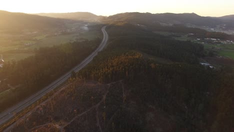 Highway-Between-Mountain-Forest-in-Autumn-Season-Aerial-View