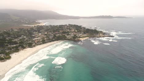 Carmel-by-the-sea-Beach-Drone-Video-Brumoso-Mañana-Surfistas-En-Olas---Acercándose-A-La-Península