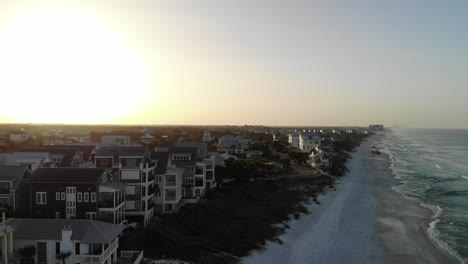 Sunrise-or-sunset-panning-aerial-shot-of-beach-homes-in-Rosemary-Beach,-Florida