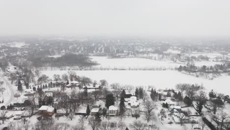 Aerial,-snow-covered-houses-in-rural-suburb-neighborhood-during-winter