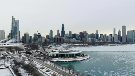 Aerial-view-towards-the-Shedd-Aquarium,-gloomy,-winter-evening-in-Chicago,-USA