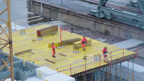 Three-construction-workers-building-a-platform.-Time-lapse