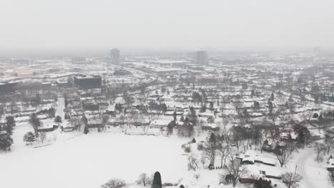 Aerial,-rural-snow-covered-suburb-community-during-winter