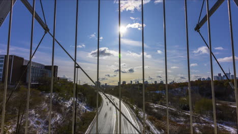 Timelapse-over-the-busy-Don-Valley-Parkway-from-the-Bloor-Street-Viaduct-in-Toronto-on-a-crisp,-snowy-Canada-Day