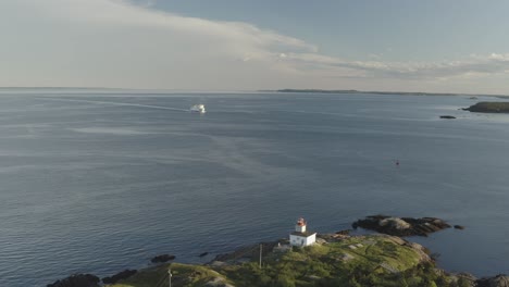 Drone-down-with-ferry-and-lighthouse-in-view