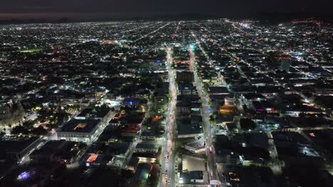 aerial-drone-tour-at-night-in-a-city-full-of-lights-and-cars-at-high-speed-in-4k