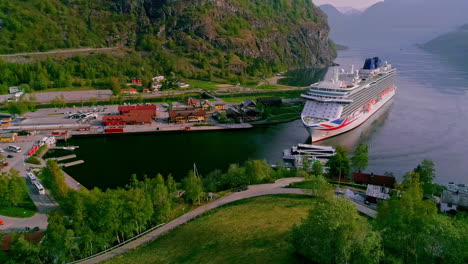 Aerial-drone-shot-of-cruise-ship-and-ferry-ship-arriving-Flam-Port-in-Norway-during-sunny-day