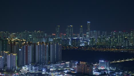 night-city-town-urban-wide-panorama-landscape-view-from-high-angle-with-constructions,-skyscrapers-and-bridges