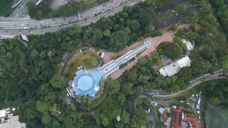 Blue-planetarium-and-a-highway-topview-in-Kuala-Lumpur,-Malaysia